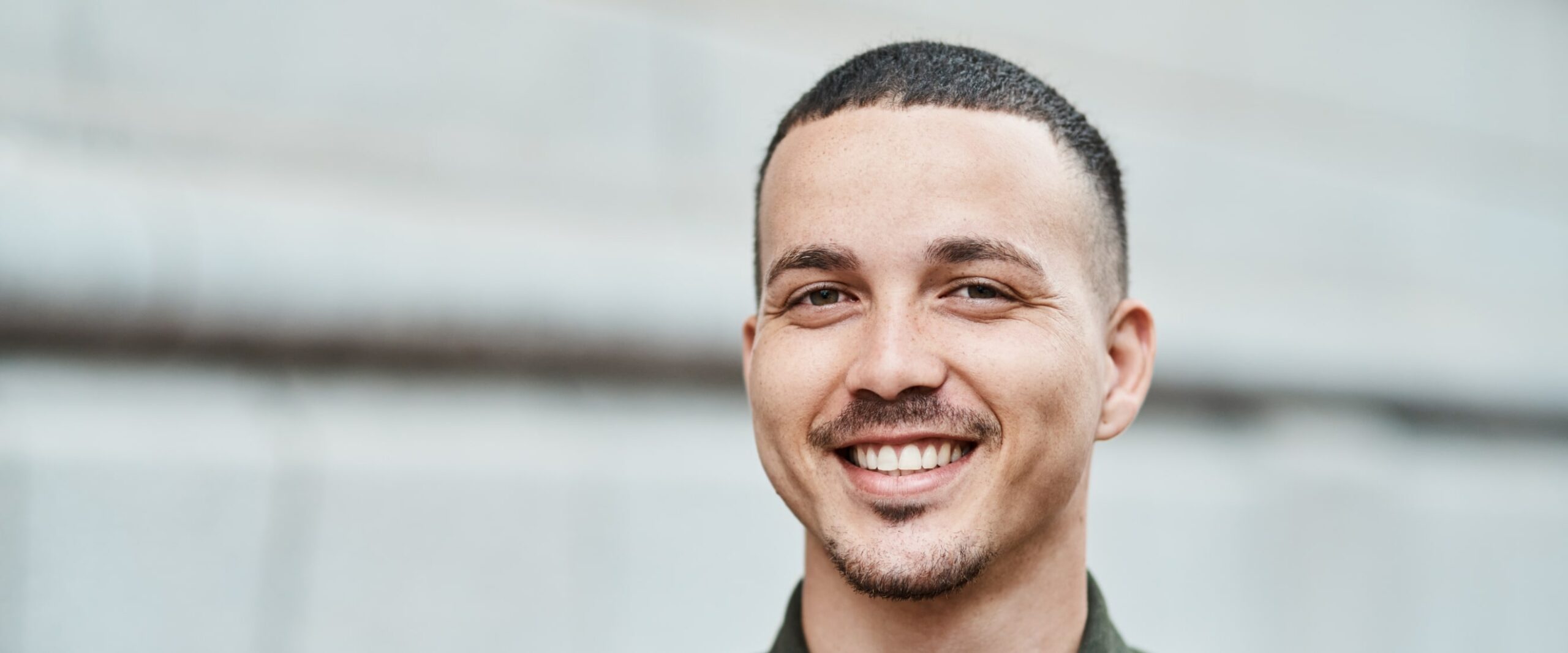 Smiling man with short hair and a goatee