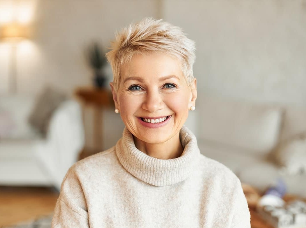 mature woman with short hair smiling with teeth