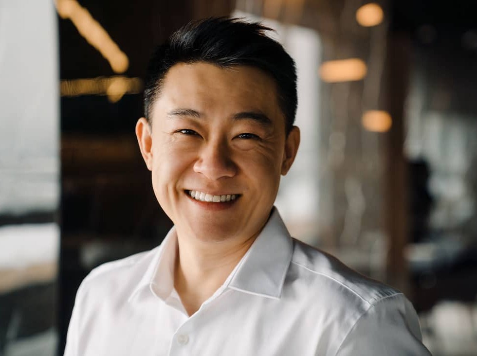 man in white shirt smiling with teeth