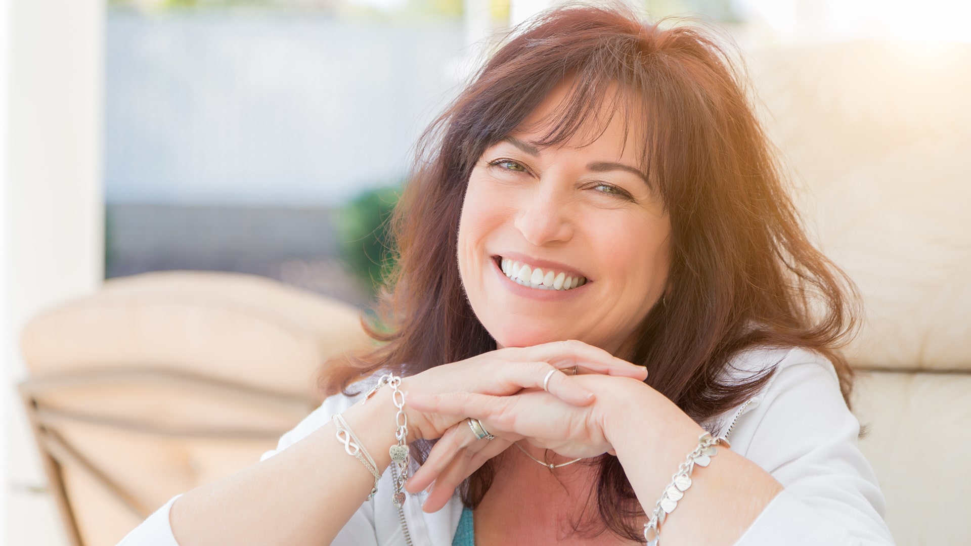 woman showing off her smile thanks to cosmetic dentistry