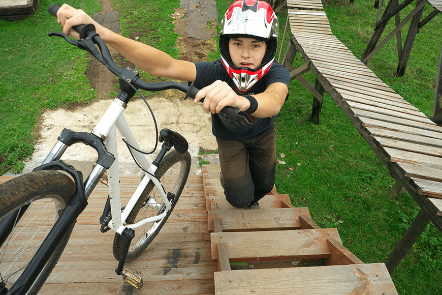 young boy go up to the ramp with his BMX Bike